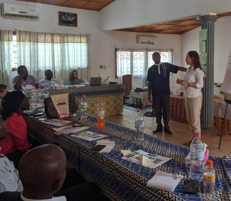 A man and a woman, leading a workshop with a group of people in CAR